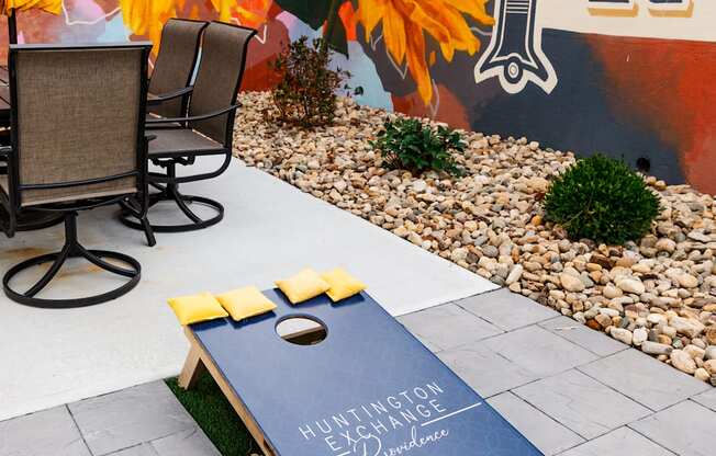 a yoga mat on the grass in a backyard with a table and chairs