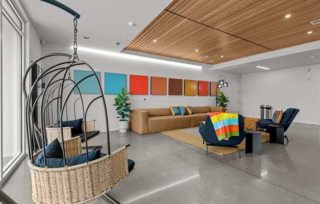 a living room with couches and chairs and a swing