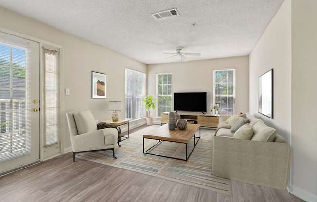 A living room with a couch, chair, and television.
