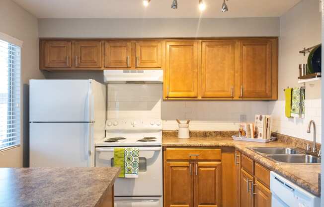 a kitchen with white appliances and wooden cabinets at Granite Bay, Phoenix, Arizona, 85023