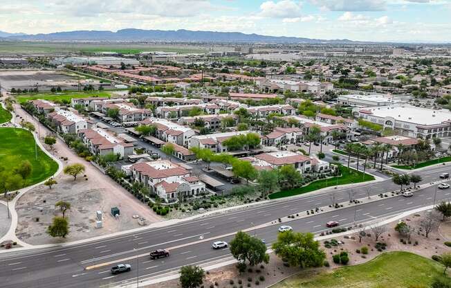 an aerial view of a suburb of a city with an empty road