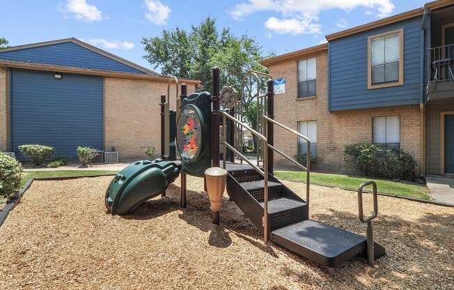 a playground at the whispering winds apartments in pearland, tx