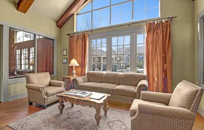 a living room with couches and chairs and a large window