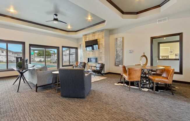 A living room with a grey carpet and brown chairs.