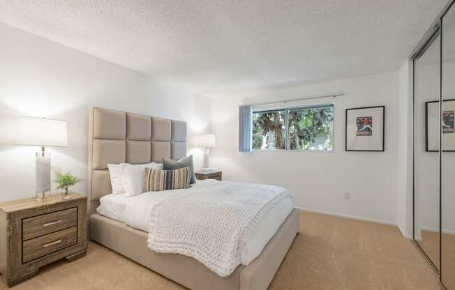 the bedroom with a large bed and a window