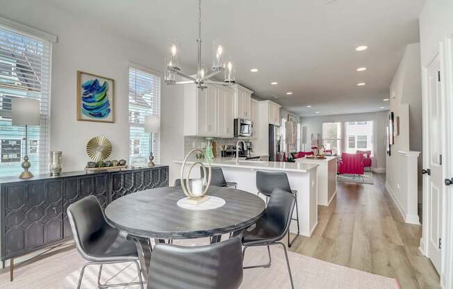 A modern dining room with a round table and chairs.