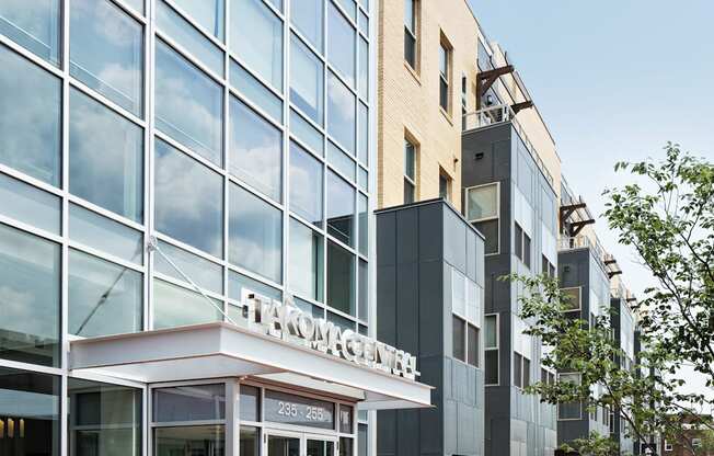 people walking in front of a building on a sidewalk