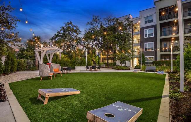 a backyard with a grass lawn and a fire pit