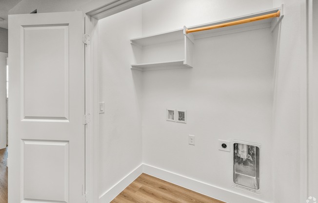 A white room with a door and a shelf. at Aurora Watson Branch, Mansfield, 76063
