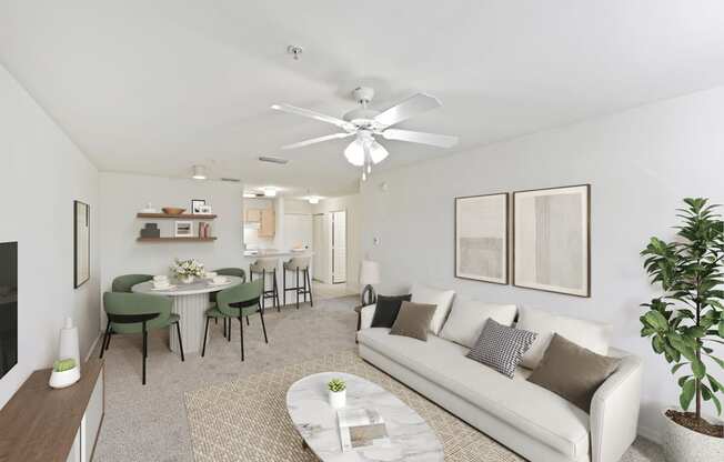 Virtually staged living area facing the kitchen with a white couch and television mounted on the wall