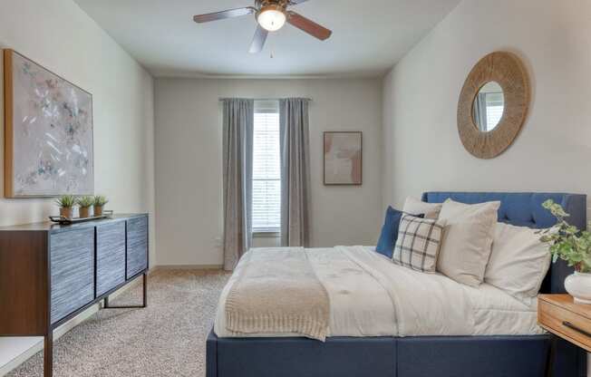 a bedroom with a large bed and a ceiling fan