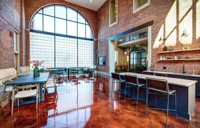 a dining room with a large window and a table and chairs