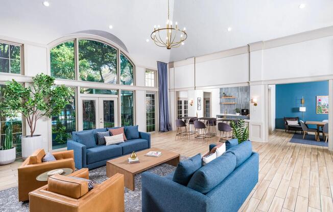 A stylish, sunlit gathering space with seamless access to the club kitchen, dining room, and outdoor views.