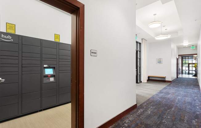 a view of a hallway with a row of lockers and a door