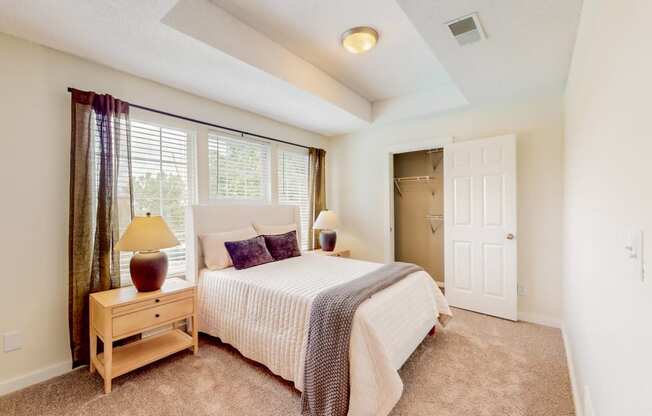 a bedroom with a large bed and a window