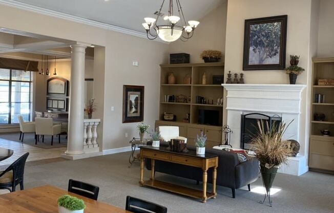 a living room with a fireplace and a table and chairs