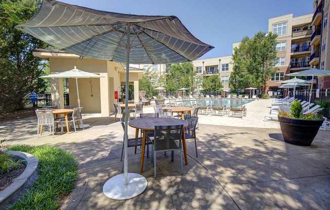 A patio with a table and chairs under a canopy.