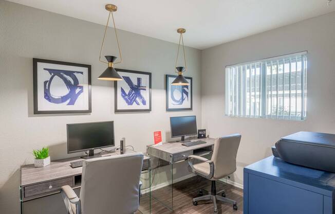 our apartments have an office with two desks and chairs and a tv