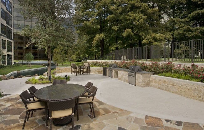 a patio with a table and chairs in a courtyard