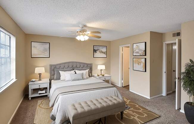 primary bedroom with a ceiling fan