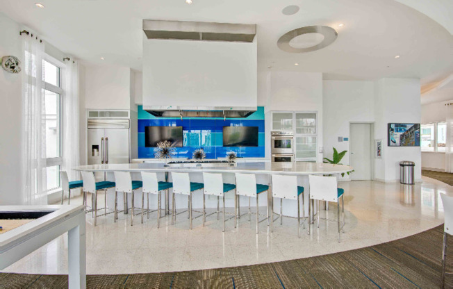 A community kitchen with light blue accents for residents of SOMA at Brickell apartments in Miami.
