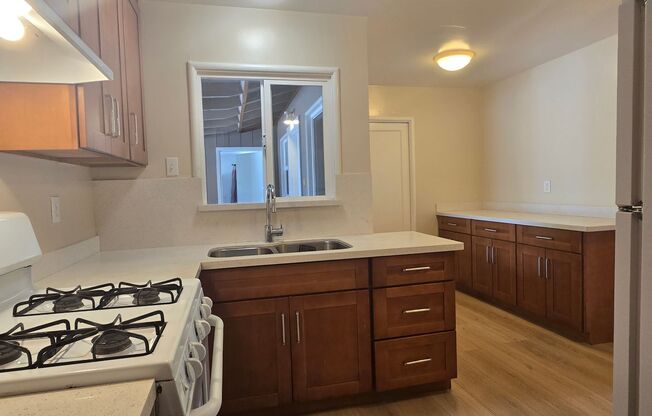 Cute Single Family Home with Large Bonus Room, Updated Kitchen, Wood Floors, Fresh Paint, Nice Yard!