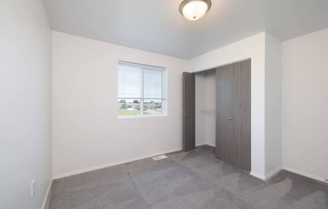 A room with a window and a door.