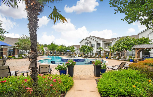 our apartments have a pool and a courtyard with chairs and plants