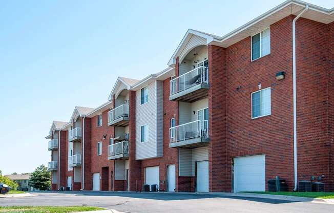 Exterior of select units featuring private garage entrances and driveway.