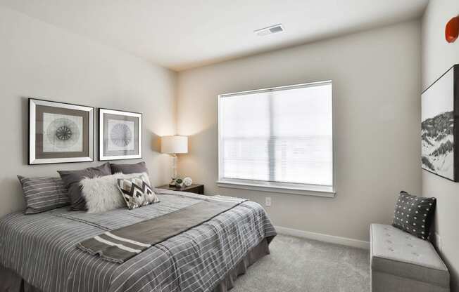 a bedroom with a bed and a window  at Aventura at Hawk Ridge, Lake St Louis, 63367