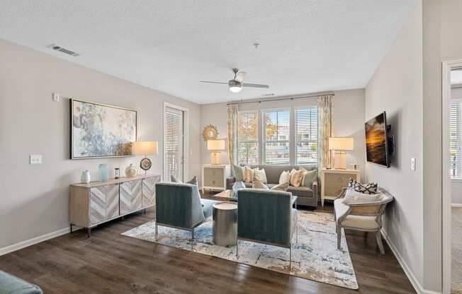 a living room with furniture and a ceiling fan