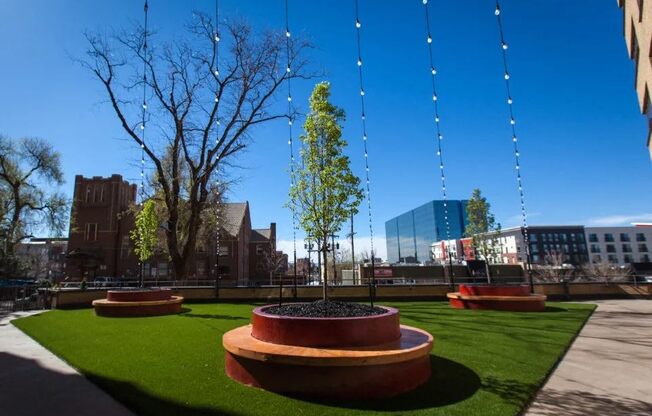 Outdoor courtyard with planters and turf at Archer Tower in Denver, CO