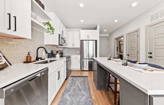A modern kitchen with white cabinets and a stainless steel dishwasher