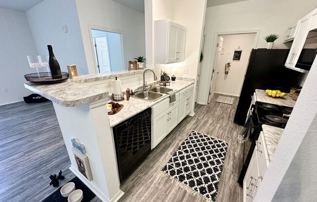 A kitchen with a white island and a sink.
