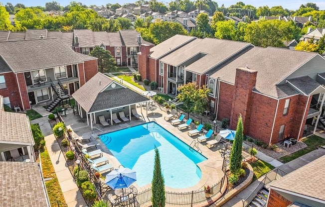 an aerial view of a swimming pool surrounded by apartments