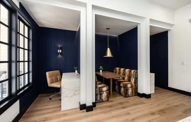 A room with a white table and chairs with a blue wall.