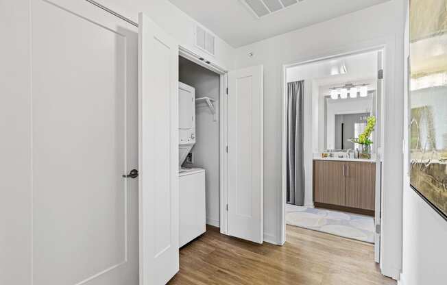 a bedroom with a medium hardwood floor and white walls