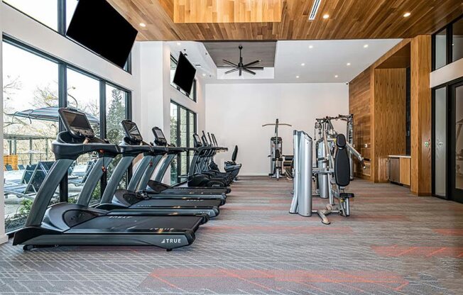 a gym with treadmills and other exercise equipment