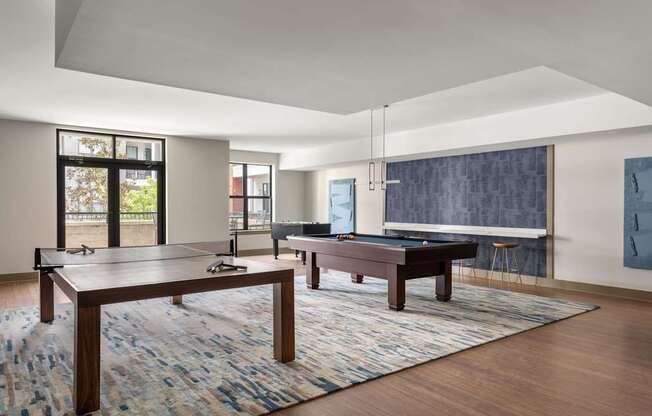 A room with a pool table and a ping pong table.