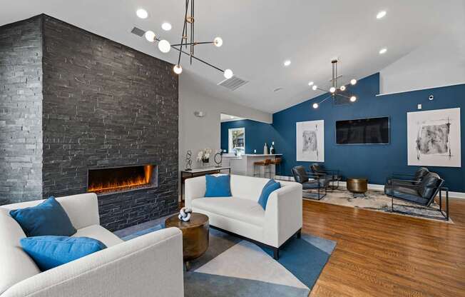 A modern living room with a fireplace and a white couch.