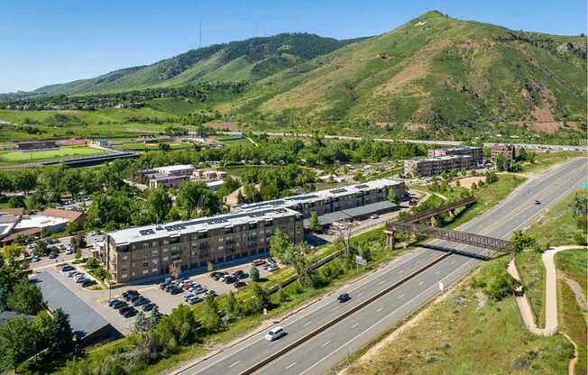 A highway with cars driving on it and a mountain in the background.