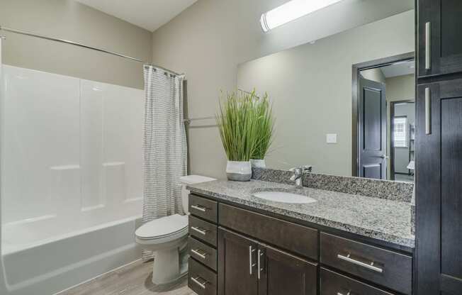 Bathroom with granite countertops at WH Flats new luxury apartments in south Lincoln NE 68516