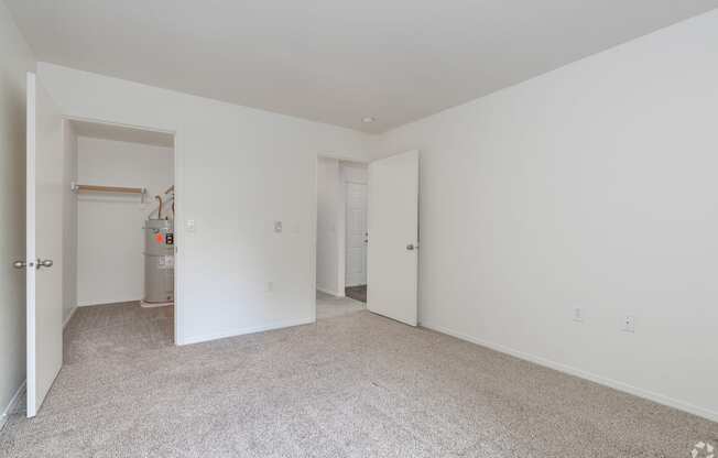 A room with white walls and carpeted floor.