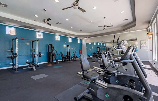 A gym with a row of treadmills and exercise equipment.at Palazzo Townhomes, Phoenix Arizona  