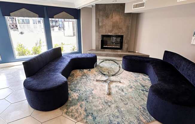 a living room with blue couches and a fireplace