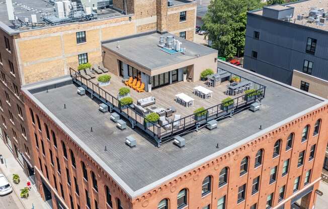 an aerial view of a brick building with a rooftop deck