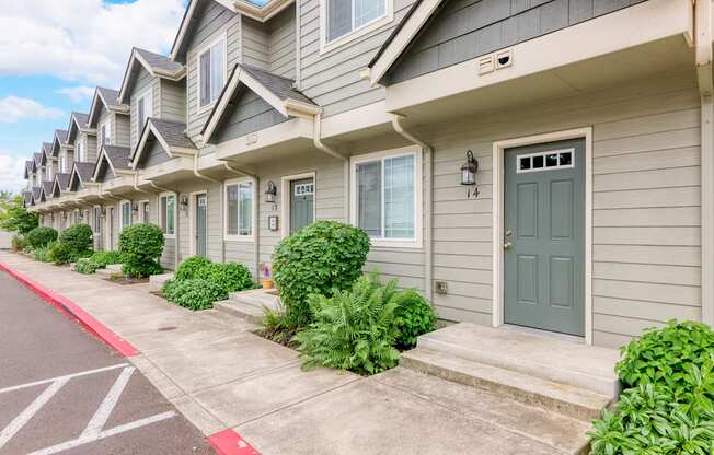 the entrance to a condo building with a green door