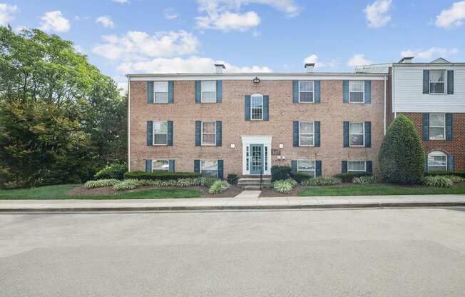 A red brick building with a white door and windows.