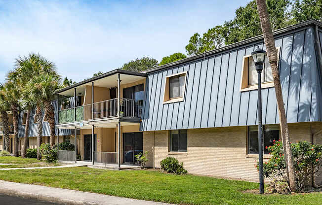 A modern two-story building with a balcony on the upper floor.