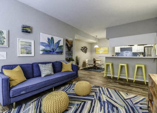 a living room with a blue couch and pillows